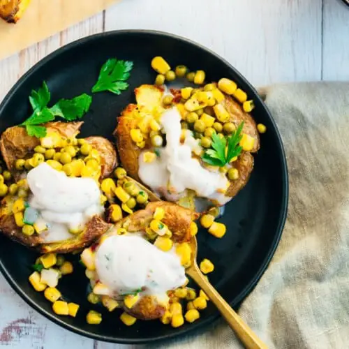 Baked potatoes with pea topping and yogurt dip