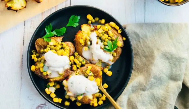 Baked potatoes with pea topping and yogurt dip