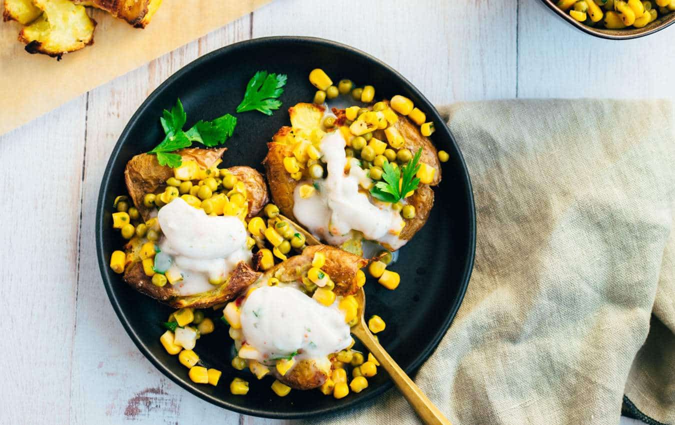 Baked potatoes with pea topping and yogurt dip