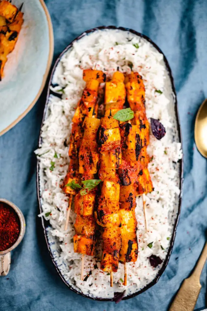 Grilled tofu pineapple skewers on rice  